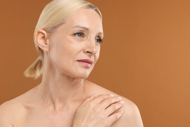 Photo of Portrait of beautiful woman on brown background, closeup