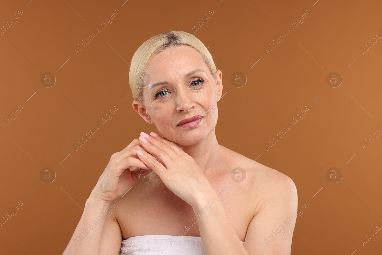 Portrait of beautiful woman on brown background Photo of Portrait of beautiful woman on brown background