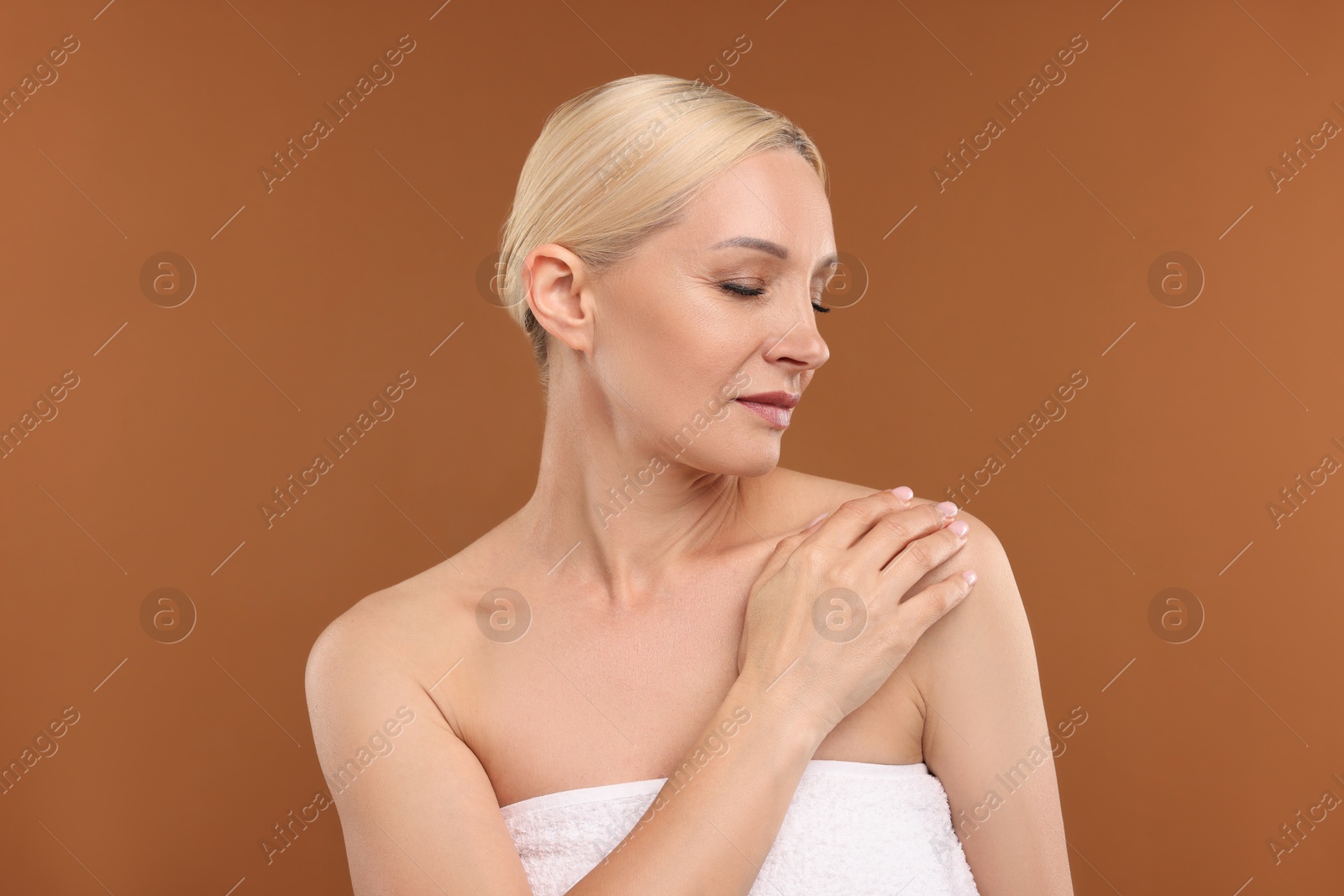 Portrait of beautiful woman on brown background Photo of Portrait of beautiful woman on brown background
