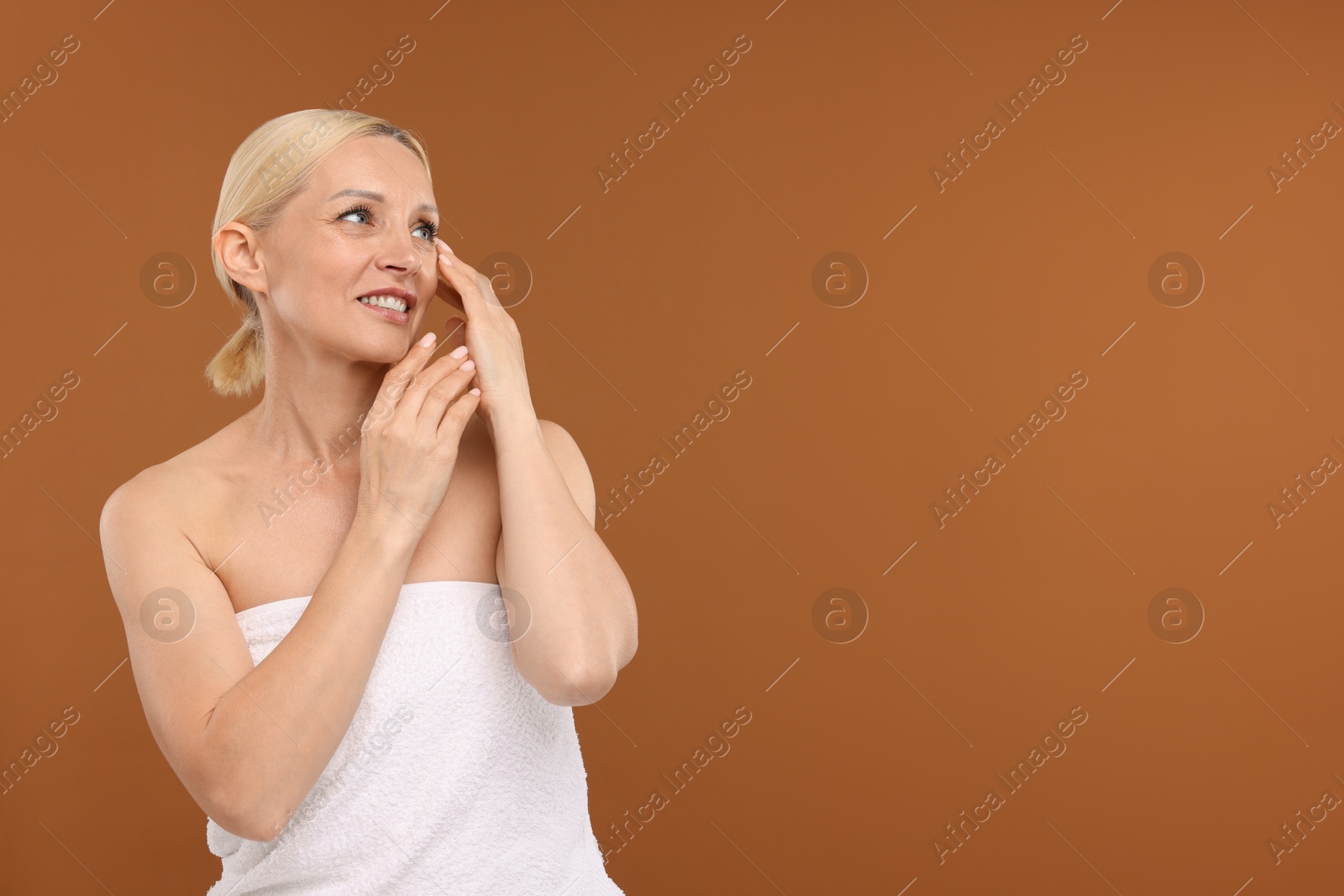 Portrait of beautiful woman on brown background. Space for text Photo of Portrait of beautiful woman on brown background. Space for text