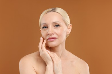 Photo of Portrait of beautiful woman on brown background