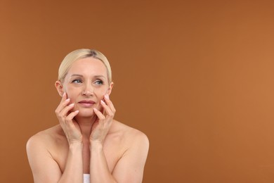 Photo of Portrait of beautiful woman on brown background. Space for text