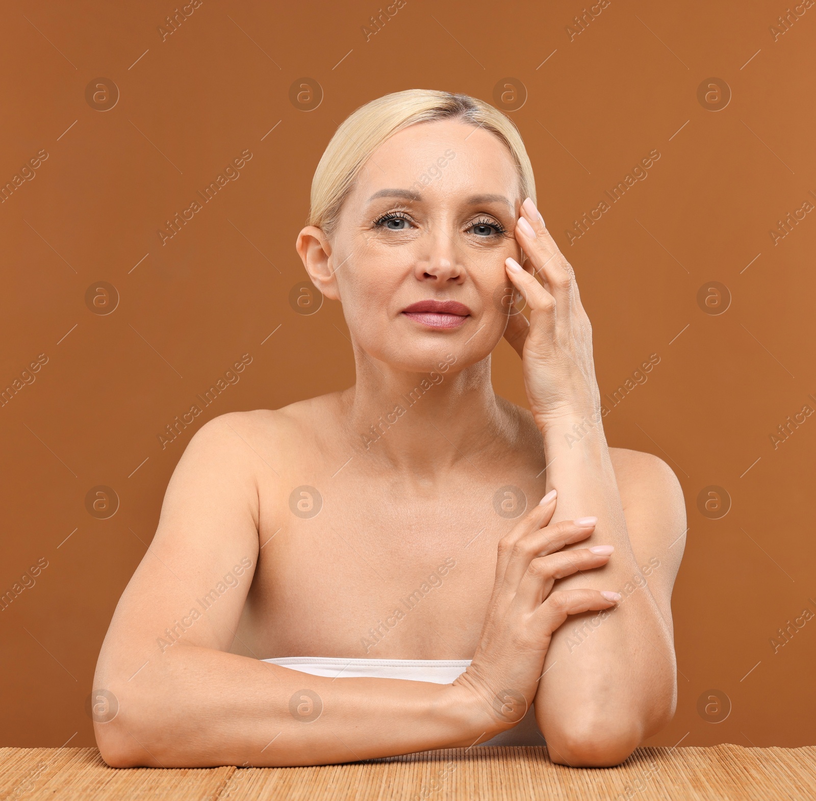 Portrait of beautiful woman on brown background Photo of Portrait of beautiful woman on brown background