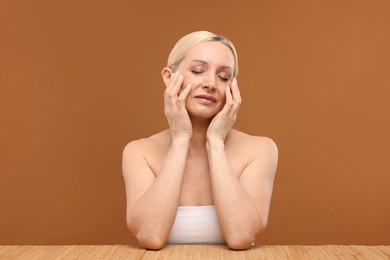 Photo of Portrait of beautiful woman on brown background