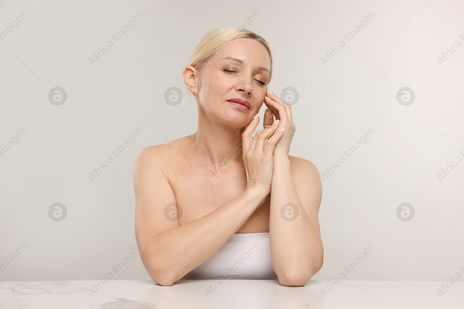 Portrait of beautiful woman on light background Photo of Portrait of beautiful woman on light background