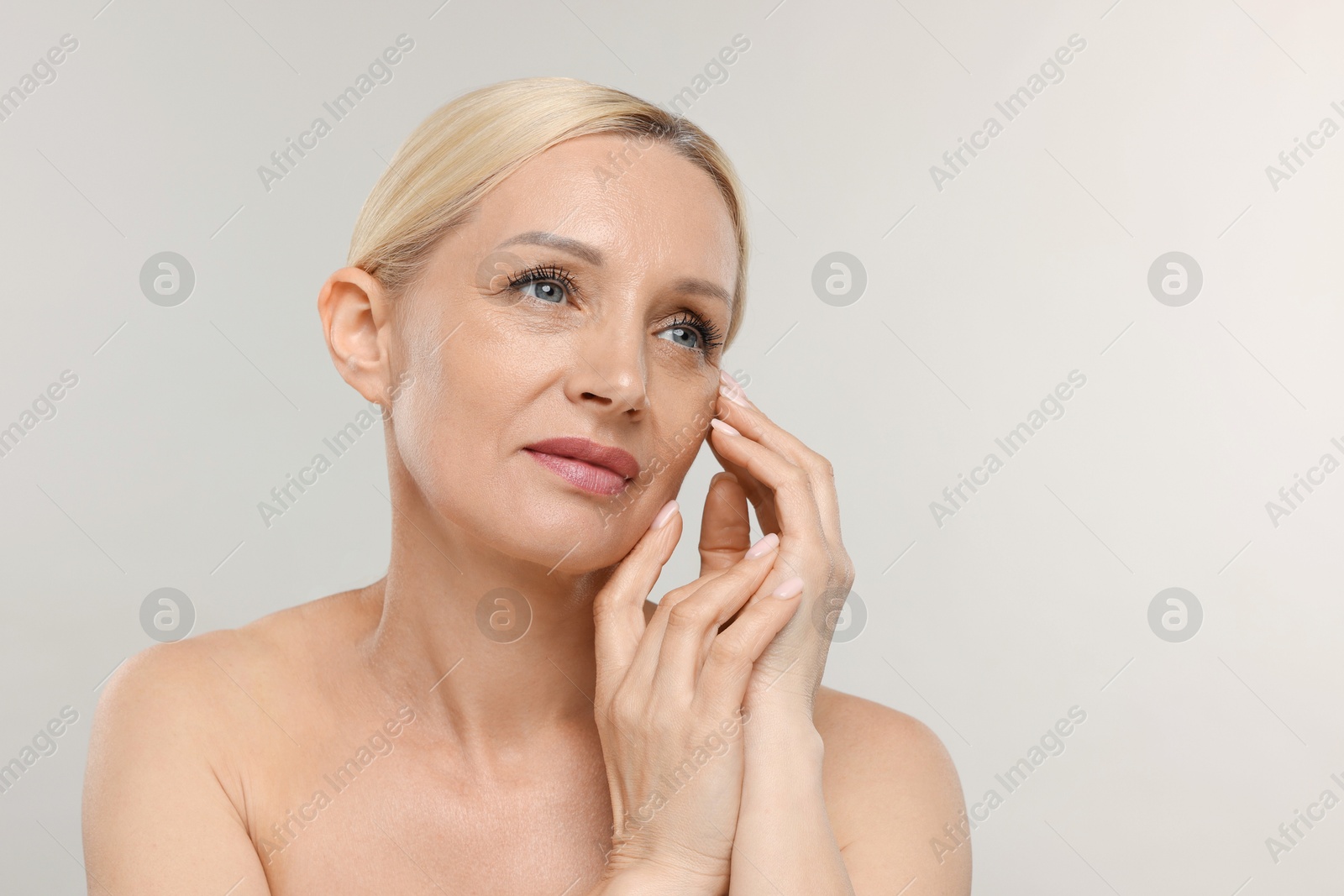 Portrait of beautiful woman on light background. Space for text Photo of Portrait of beautiful woman on light background. Space for text