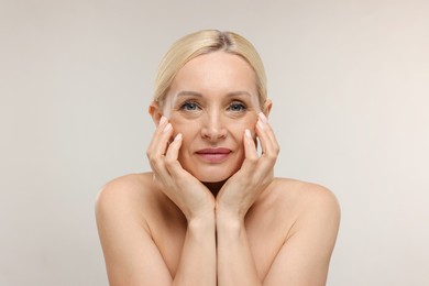 Photo of Portrait of beautiful woman on light background