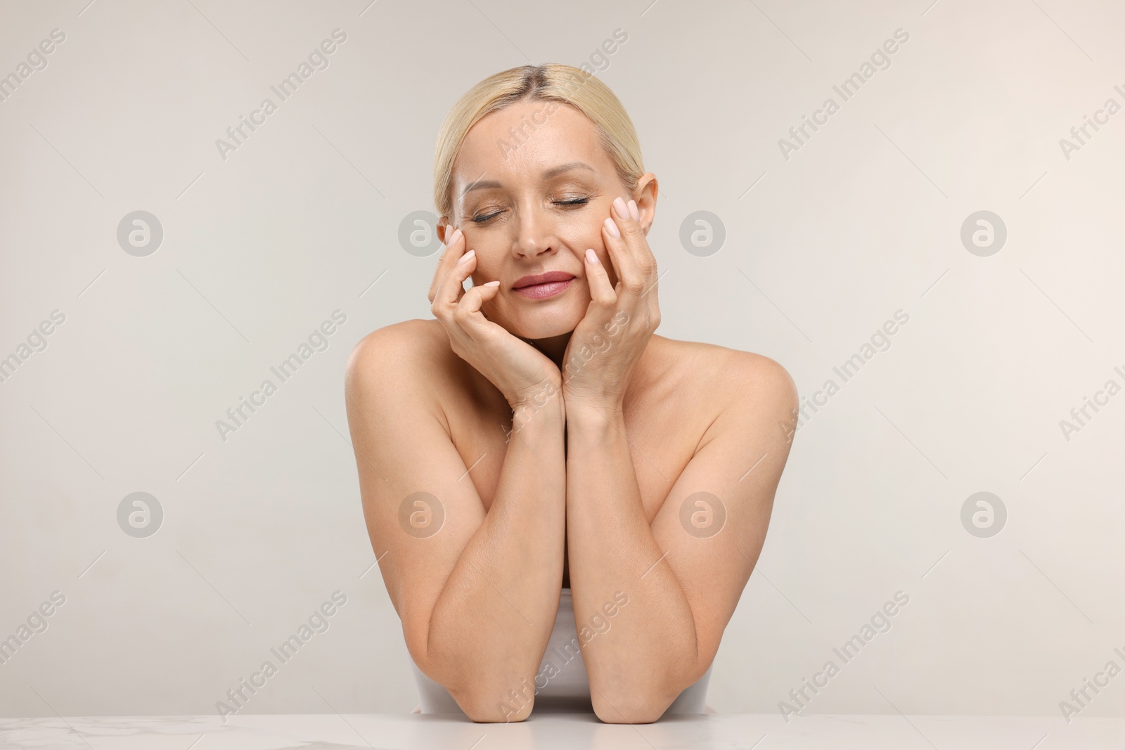 Portrait of beautiful woman on light background Photo of Portrait of beautiful woman on light background