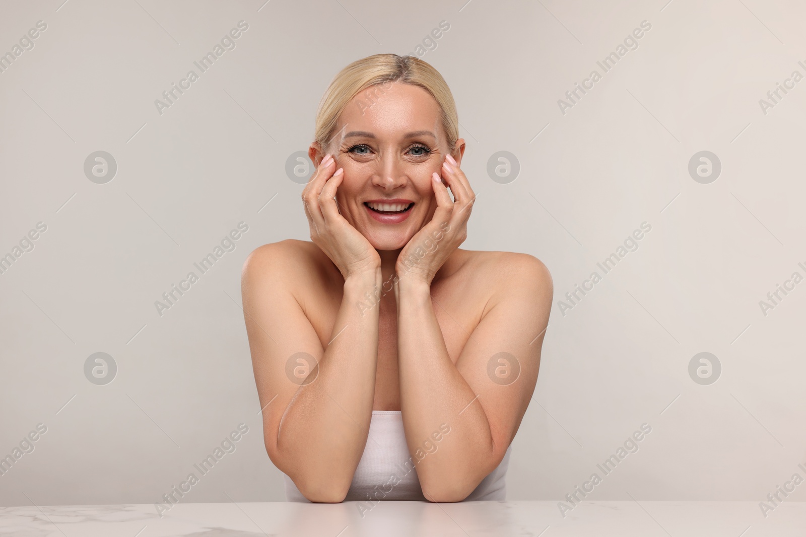 Portrait of beautiful woman on light background Photo of Portrait of beautiful woman on light background