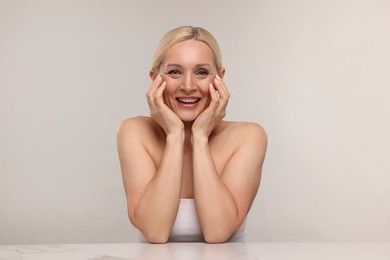 Photo of Portrait of beautiful woman on light background