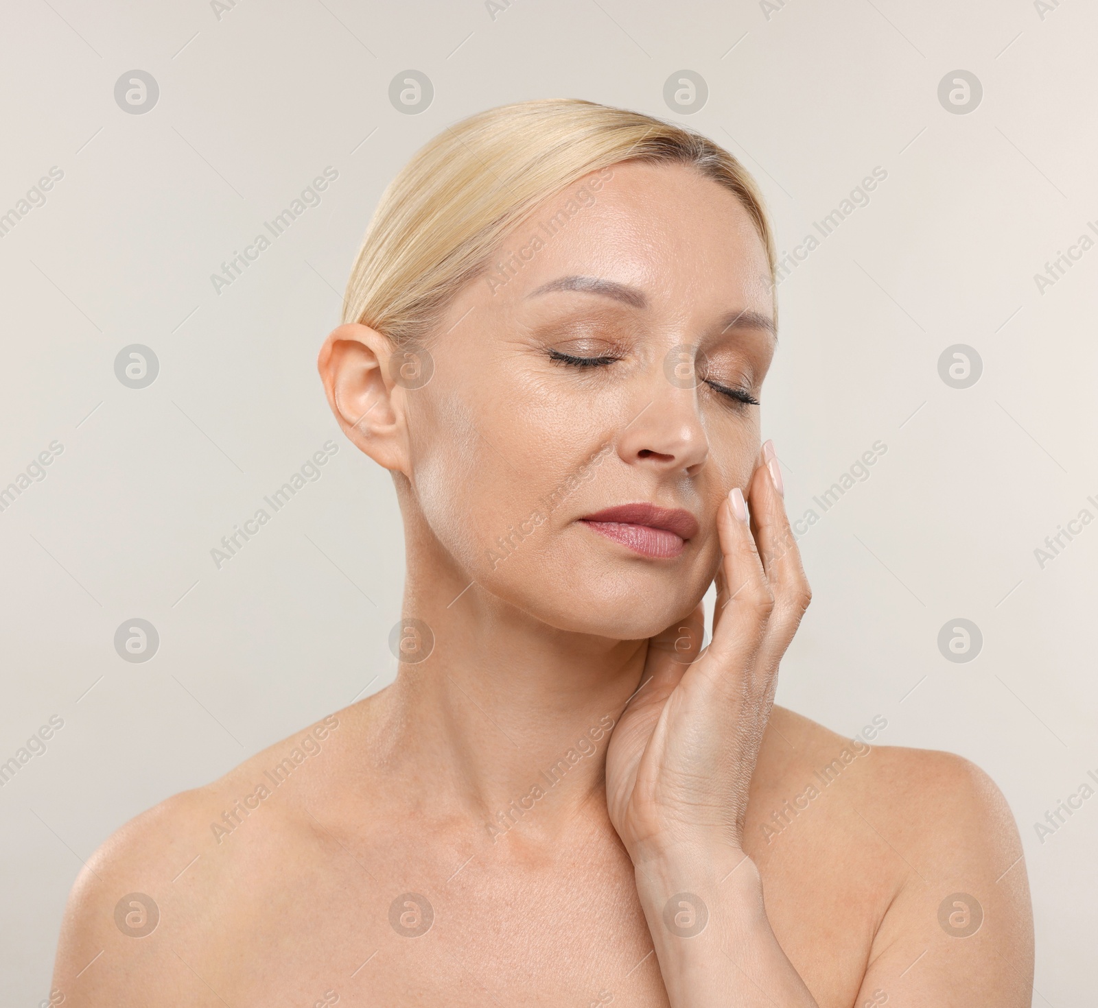 Portrait of beautiful woman on light background Photo of Portrait of beautiful woman on light background
