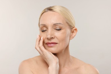 Photo of Portrait of beautiful woman on light background
