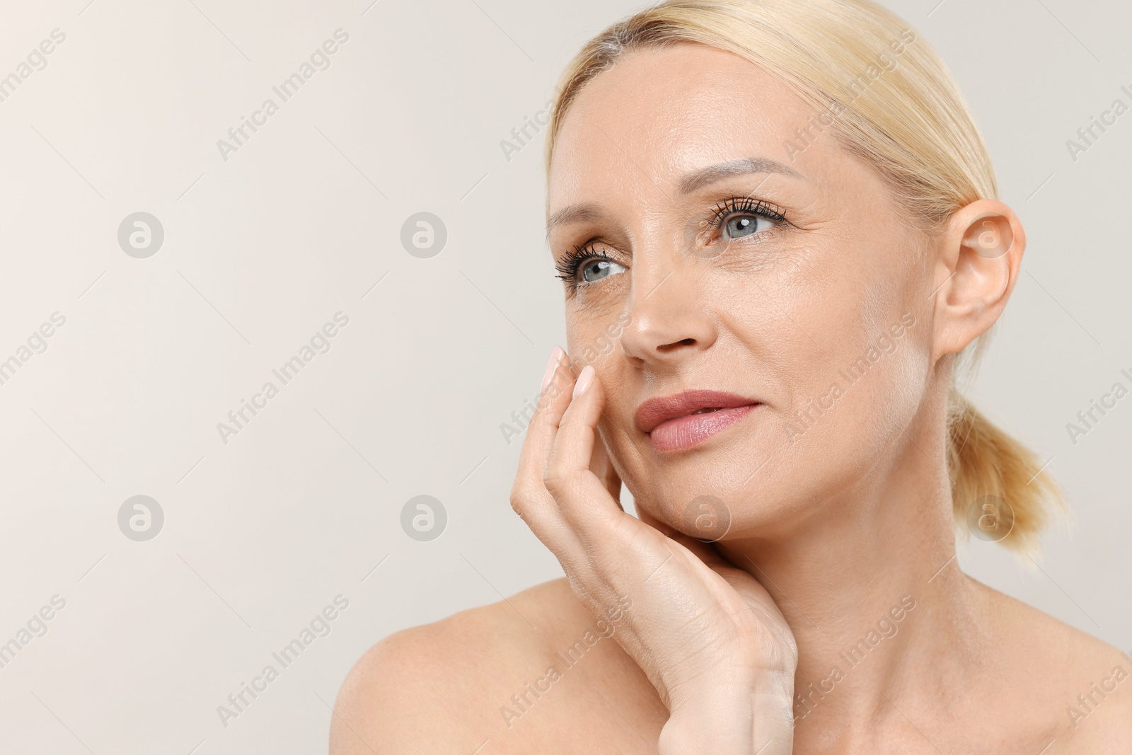 Portrait of beautiful woman on light background, closeup. Space for text Photo of Portrait of beautiful woman on light background, closeup. Space for text