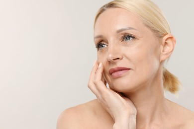 Photo of Portrait of beautiful woman on light background, closeup. Space for text
