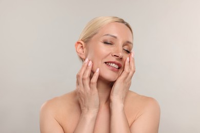 Photo of Portrait of beautiful woman on light background