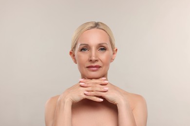 Photo of Portrait of beautiful woman on light background