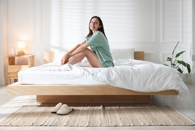 Photo of Woman on bed with soft mattress at home