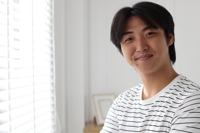 Photo of Portrait of handsome man at home. Space for text