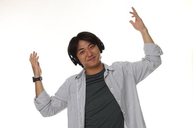 Photo of Handsome Asian man in headphones on white background