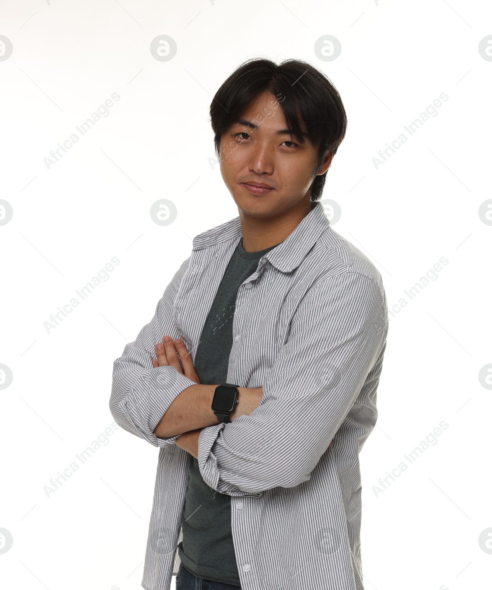 Portrait of handsome Asian man with crossed arms on white background Photo of Portrait of handsome Asian man with crossed arms on white background