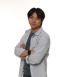 Photo of Portrait of handsome Asian man with crossed arms on white background