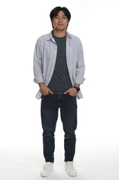 Photo of Handsome Asian man posing on white background