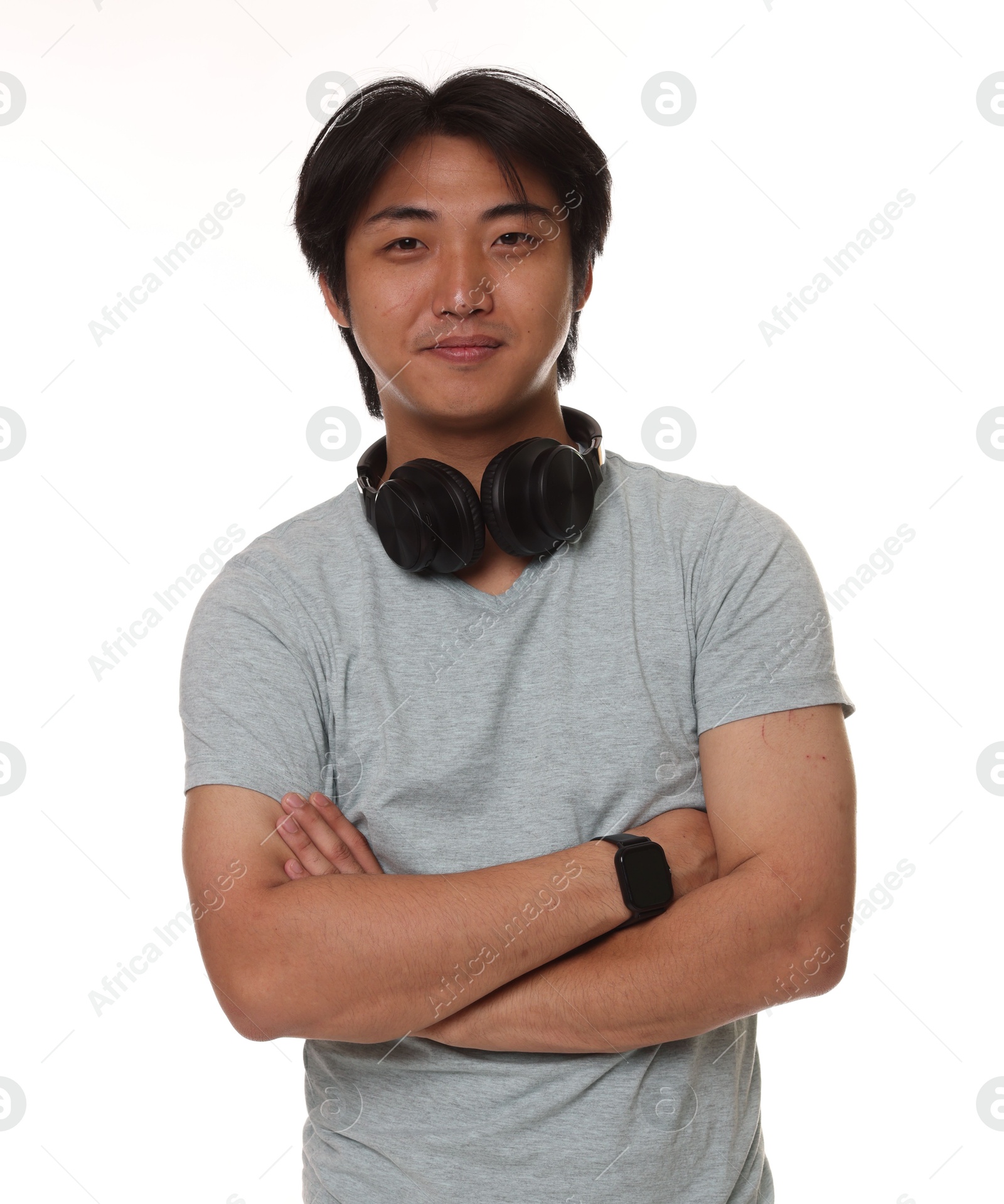 Portrait of handsome Asian man with headphones on white background Photo of Portrait of handsome Asian man with headphones on white background