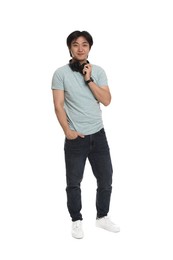 Photo of Handsome Asian man with headphones on white background