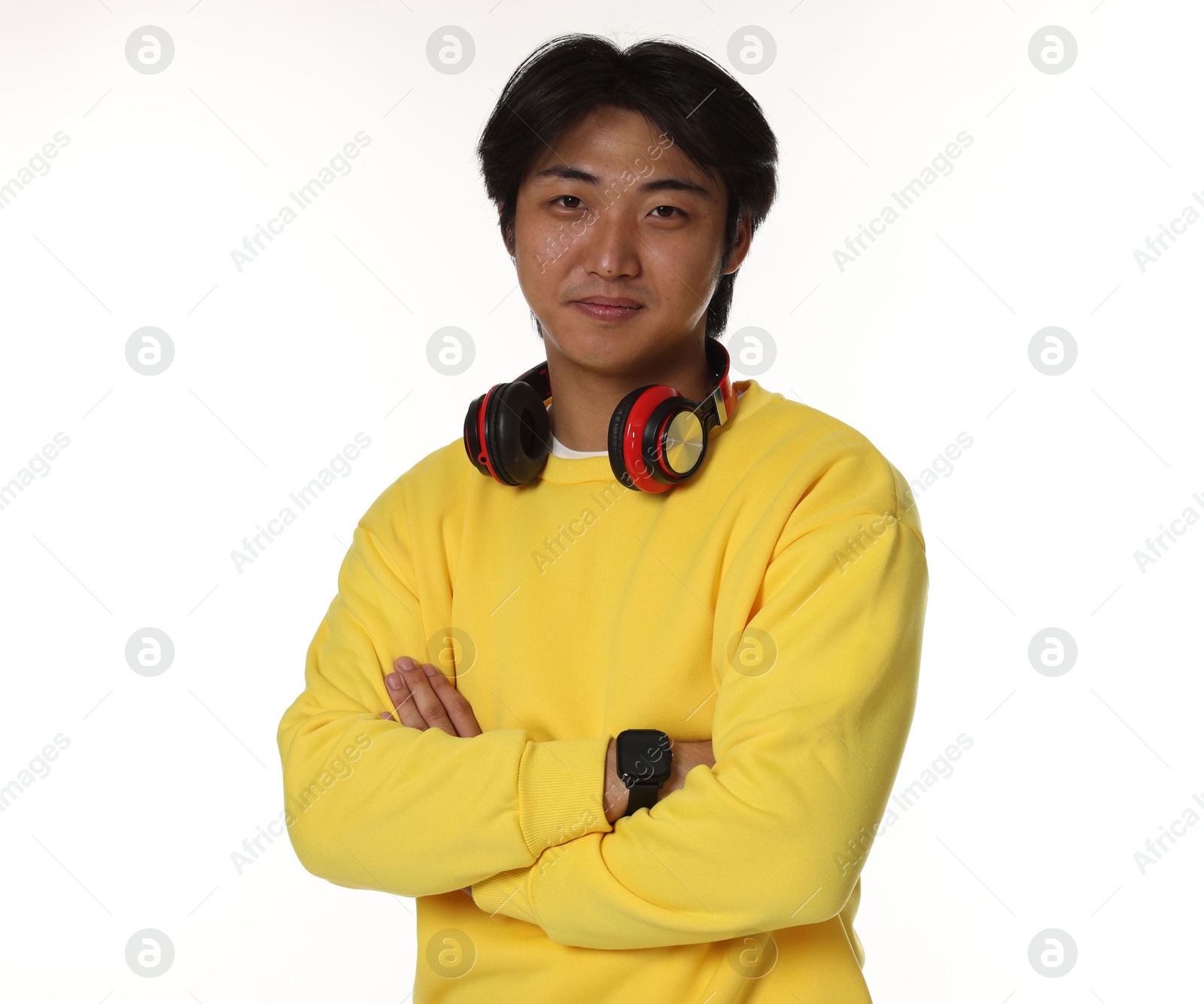 Portrait of handsome Asian man with headphones on white background Photo of Portrait of handsome Asian man with headphones on white background