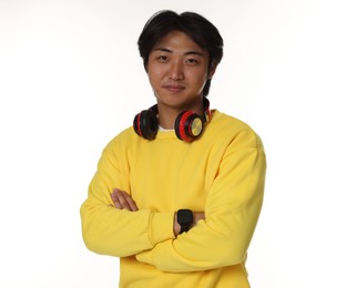 Photo of Portrait of handsome Asian man with headphones on white background