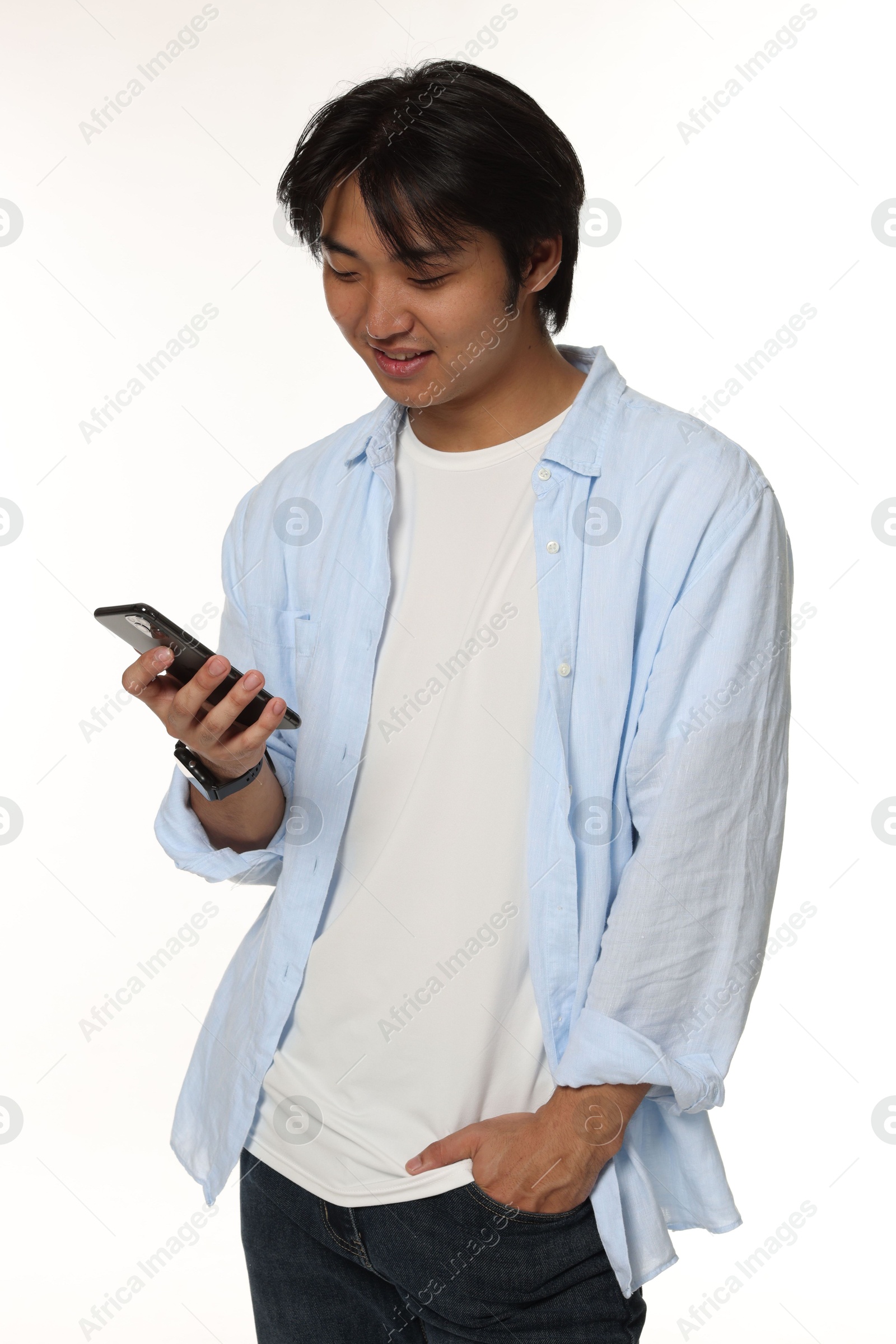 Handsome Asian man with smartphone on white background Photo of Handsome Asian man with smartphone on white background