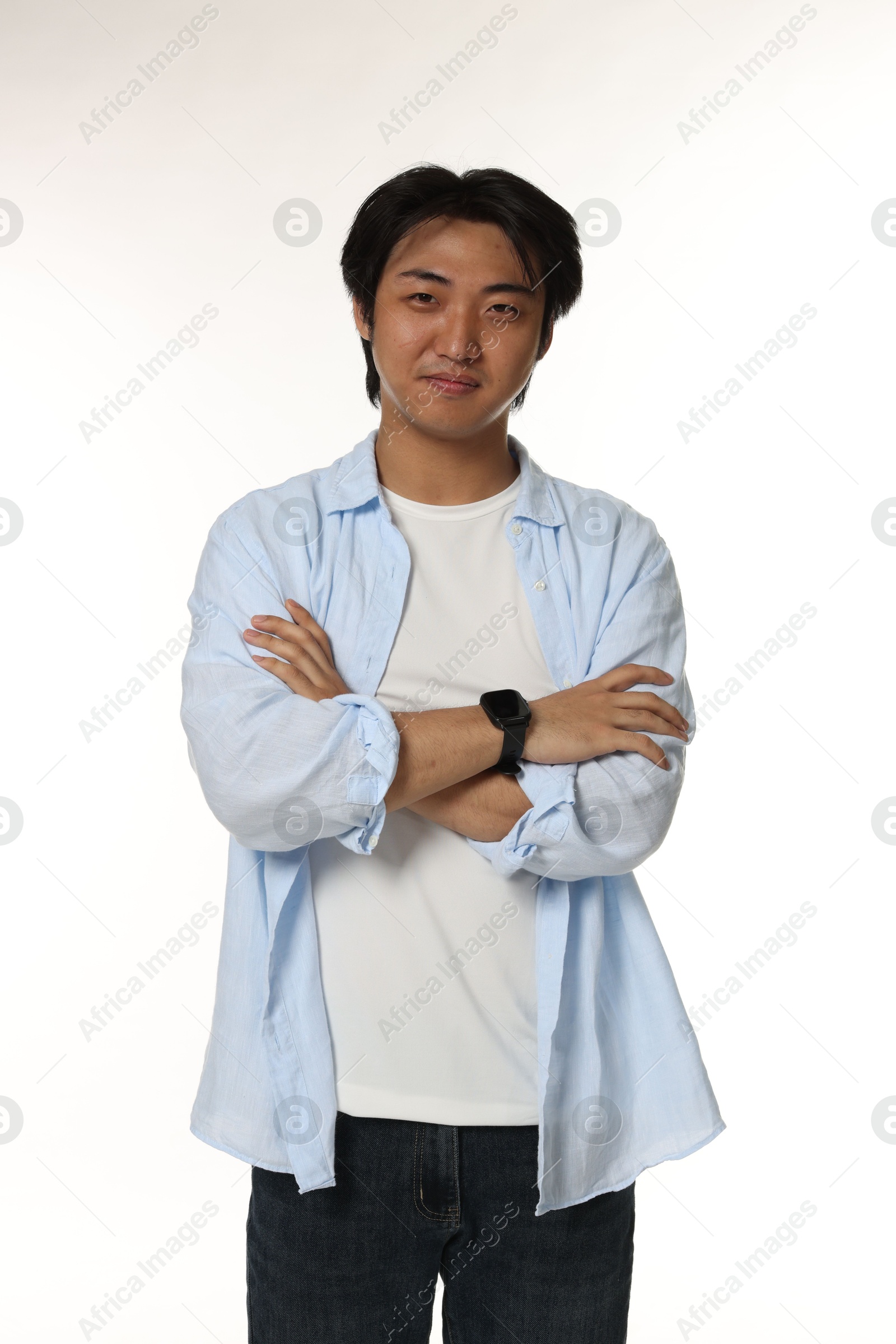 Portrait of handsome Asian man with crossed arms on white background Photo of Portrait of handsome Asian man with crossed arms on white background