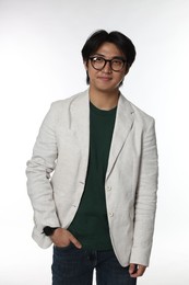 Photo of Portrait of handsome Asian man in glasses on white background