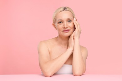 Photo of Portrait of beautiful woman on light pink background