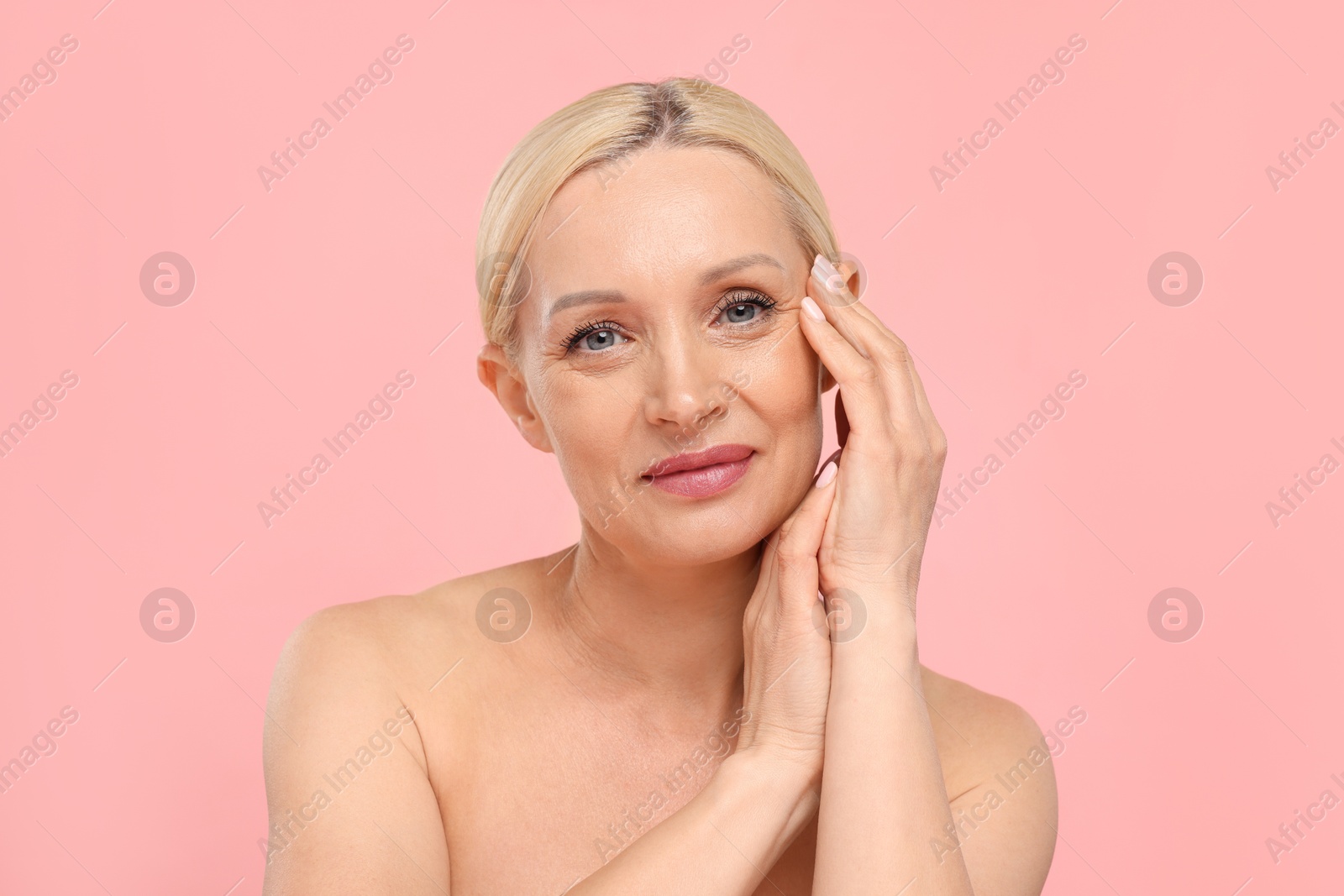 Portrait of beautiful woman on light pink background Photo of Portrait of beautiful woman on light pink background