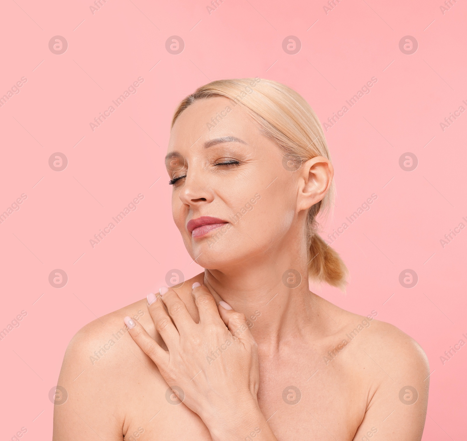 Portrait of beautiful woman on light pink background Photo of Portrait of beautiful woman on light pink background