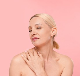 Photo of Portrait of beautiful woman on light pink background