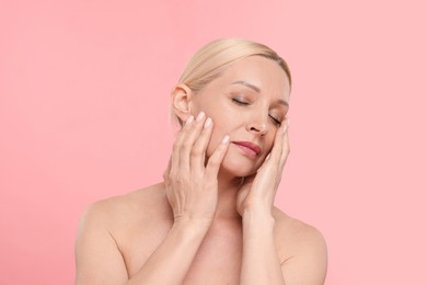 Photo of Portrait of beautiful woman on light pink background