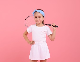 Photo of Little girl with tennis racket on pink background