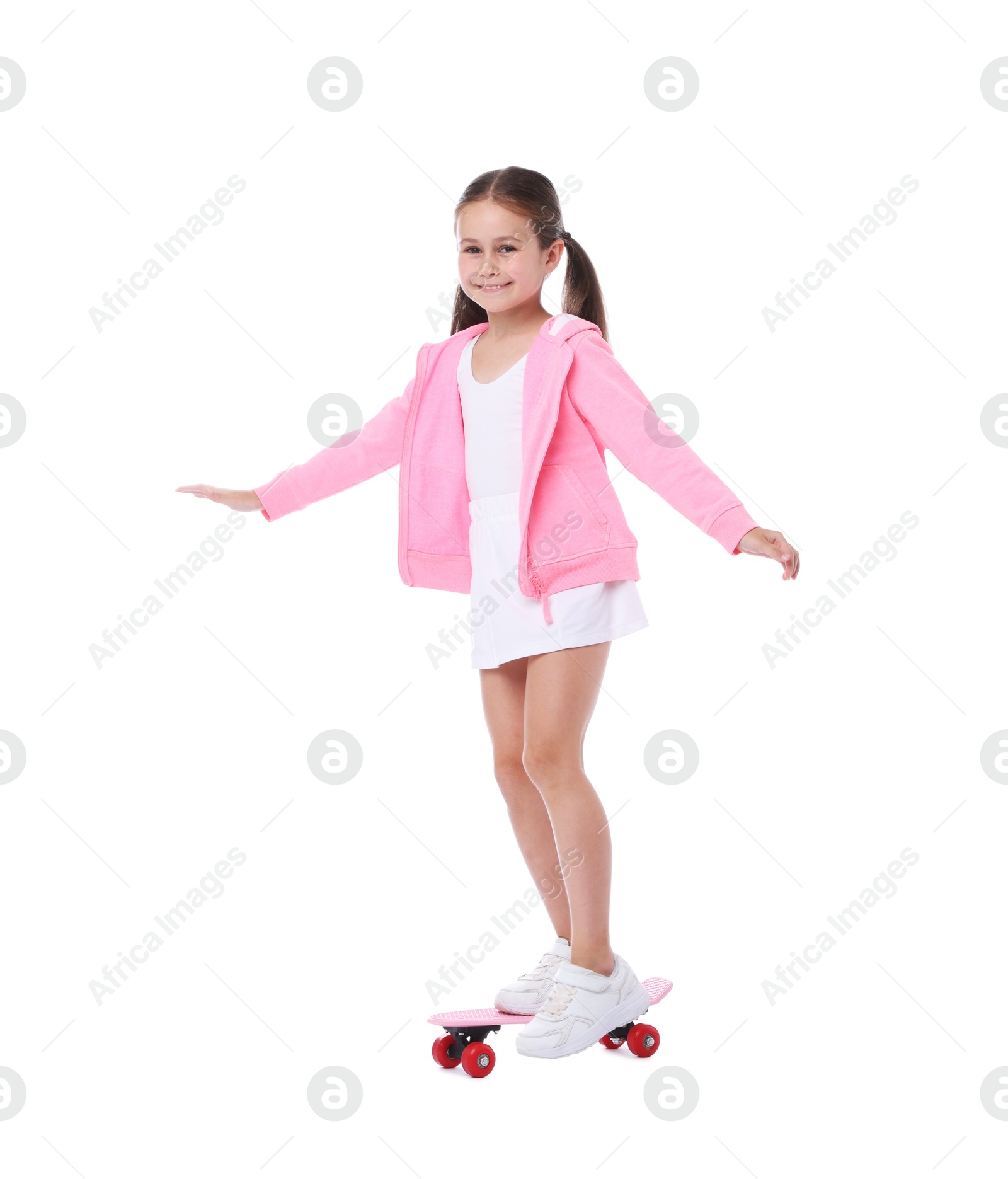 Little girl with penny board on white background Photo of Little girl with penny board on white background