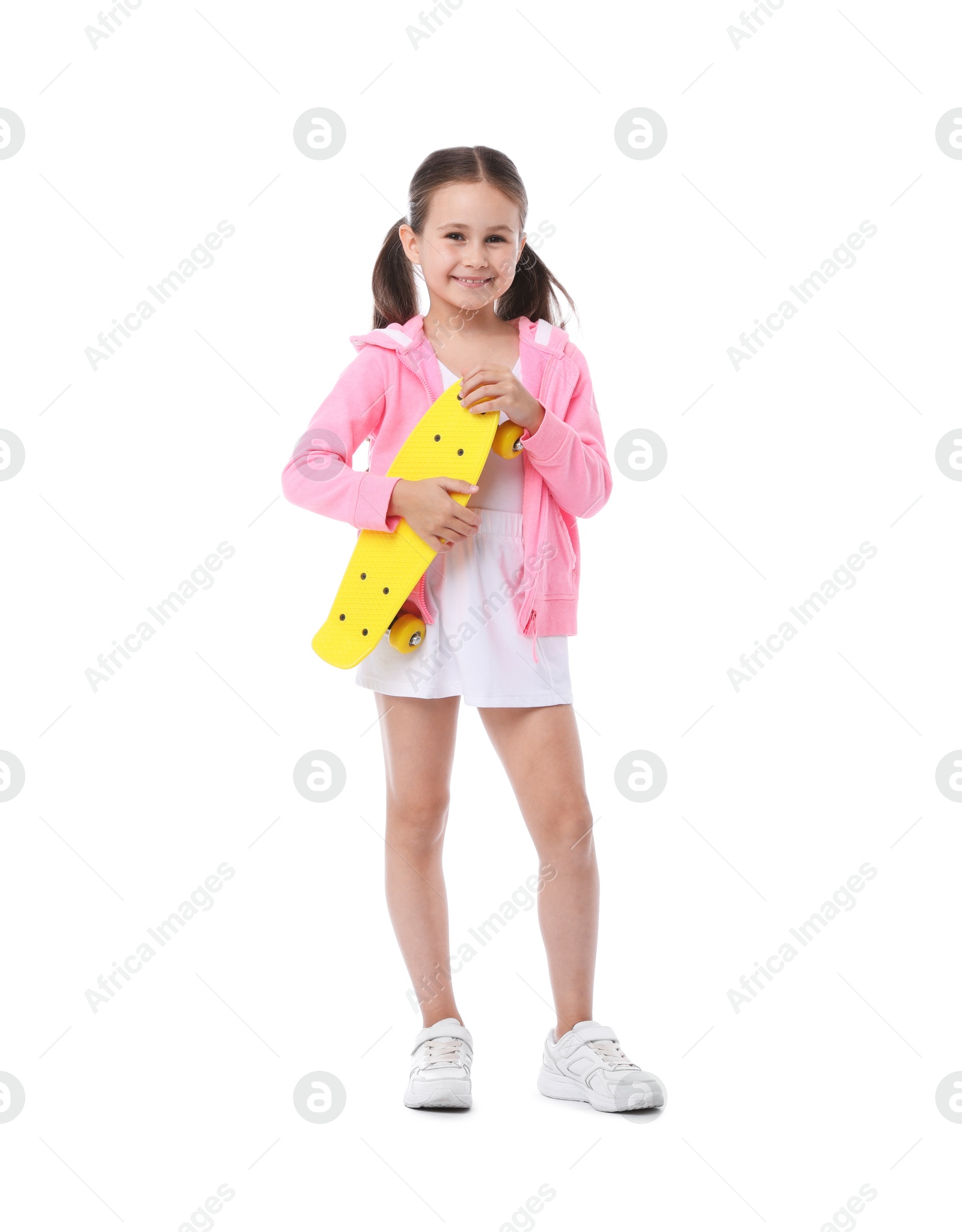 Little girl with penny board on white background Photo of Little girl with penny board on white background