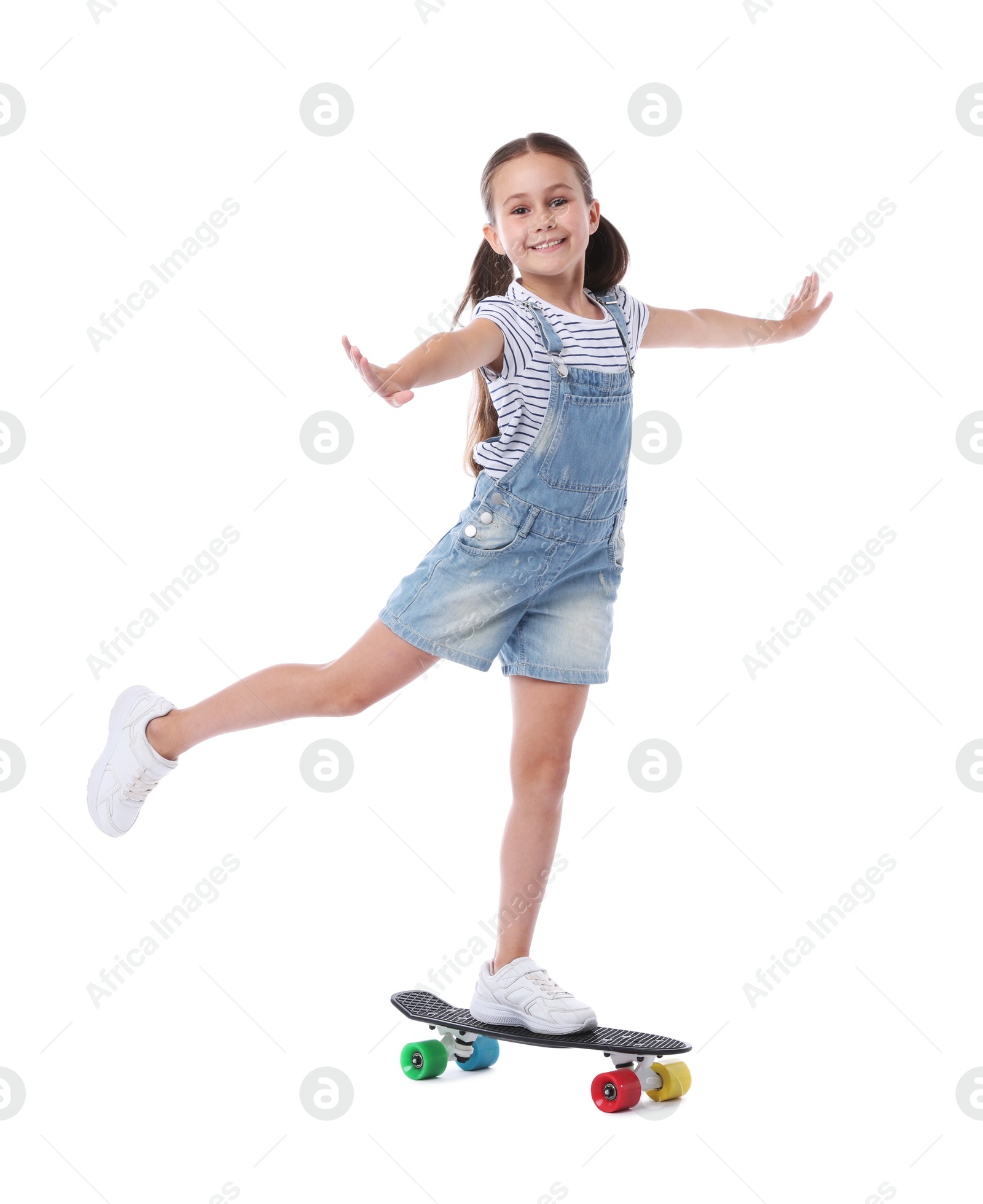 Little girl with penny board on white background Photo of Little girl with penny board on white background