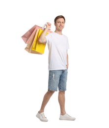 Photo of Cheerful man with shopping bags on white background