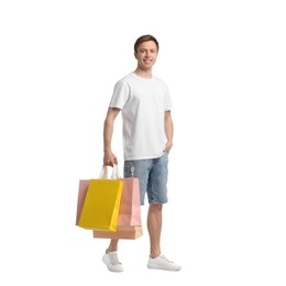 Photo of Cheerful man with shopping bags on white background