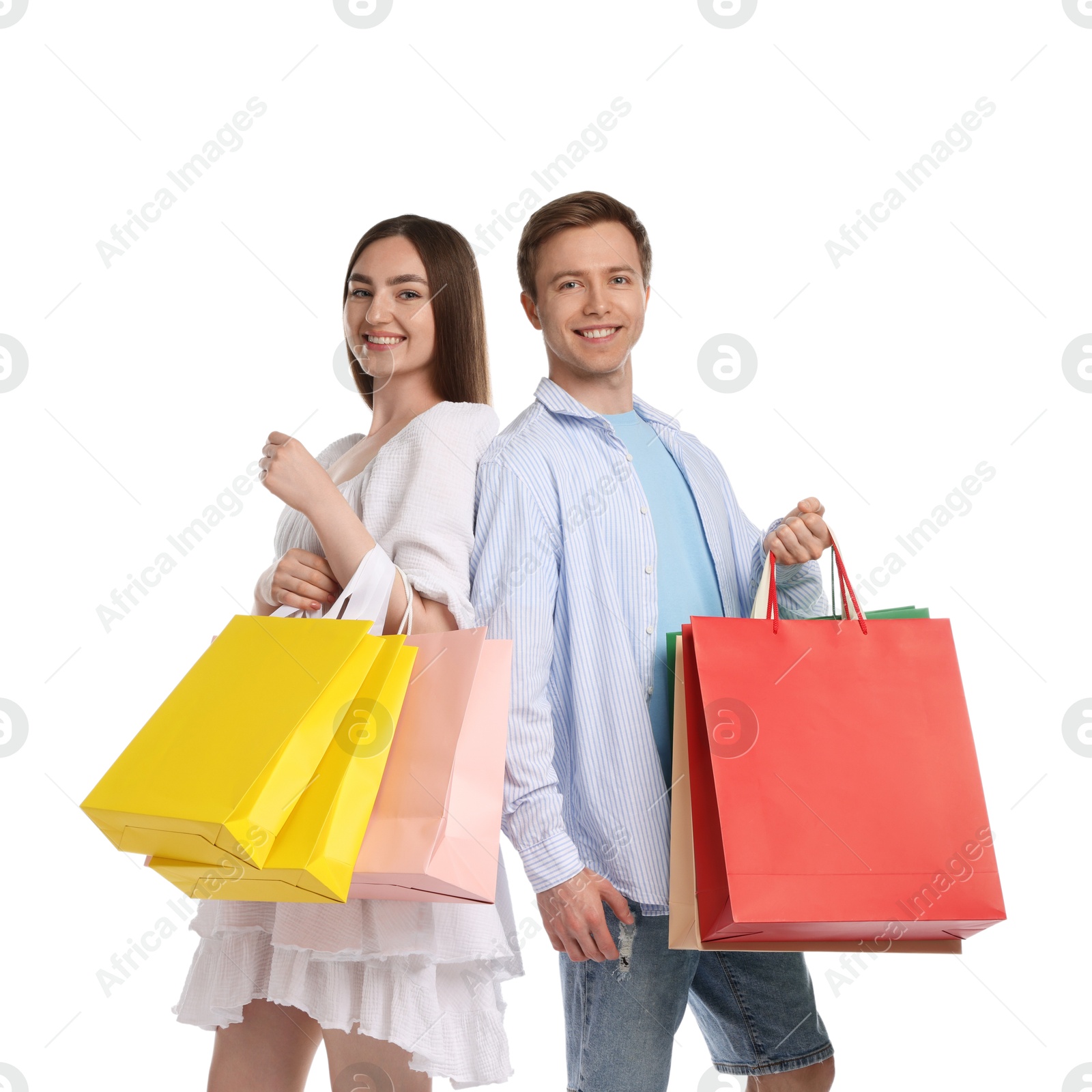 Happy couple with shopping bags on white background Photo of Happy couple with shopping bags on white background
