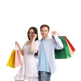 Photo of Happy couple with shopping bags on white background