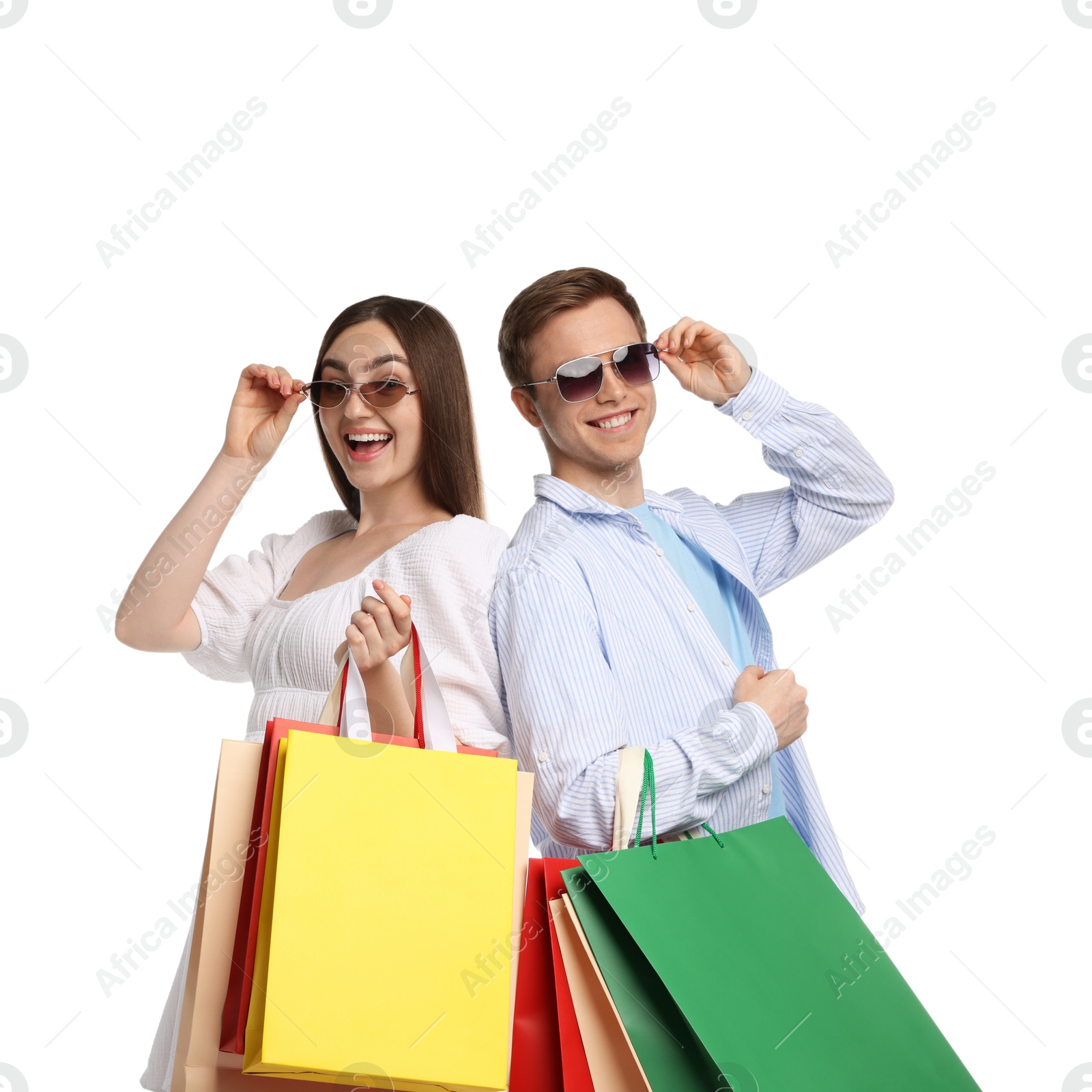 Happy couple with shopping bags on white background Photo of Happy couple with shopping bags on white background