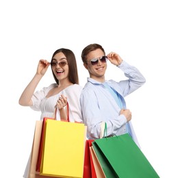 Photo of Happy couple with shopping bags on white background