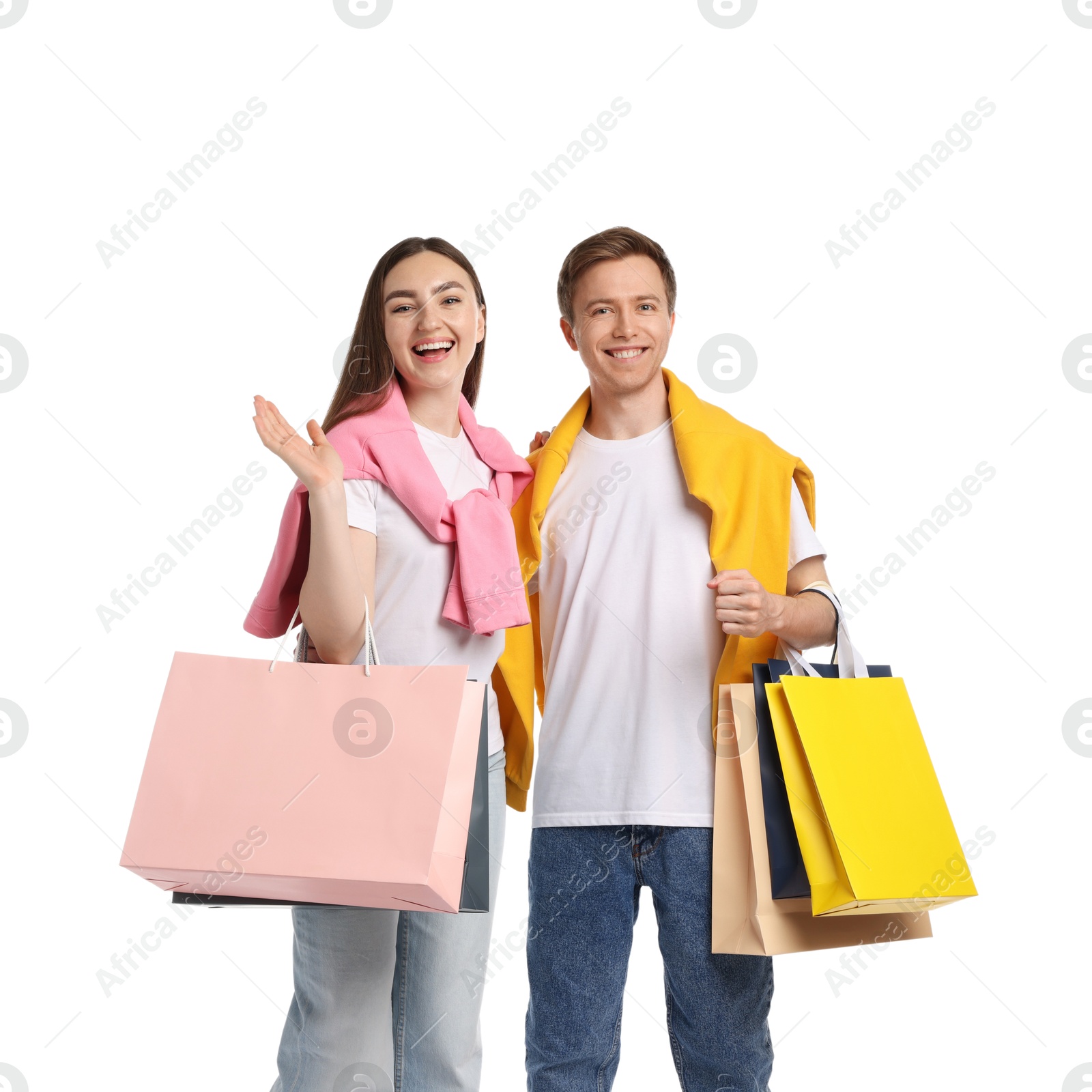 Happy couple with shopping bags on white background Photo of Happy couple with shopping bags on white background