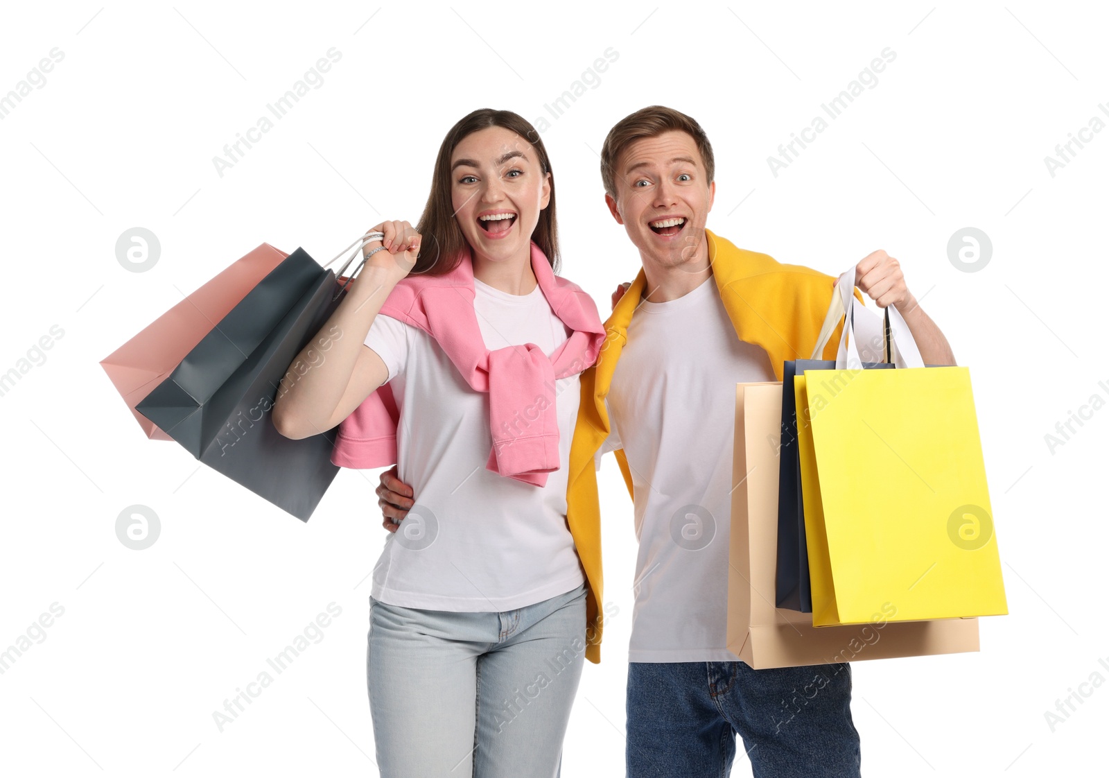 Happy couple with shopping bags on white background Photo of Happy couple with shopping bags on white background